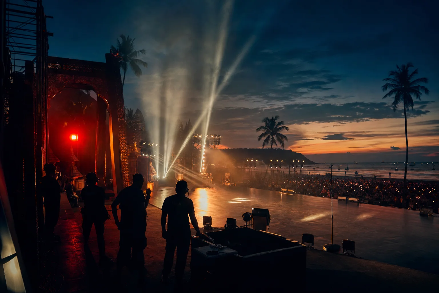 An event production team preparing a stage in Goa at dusk